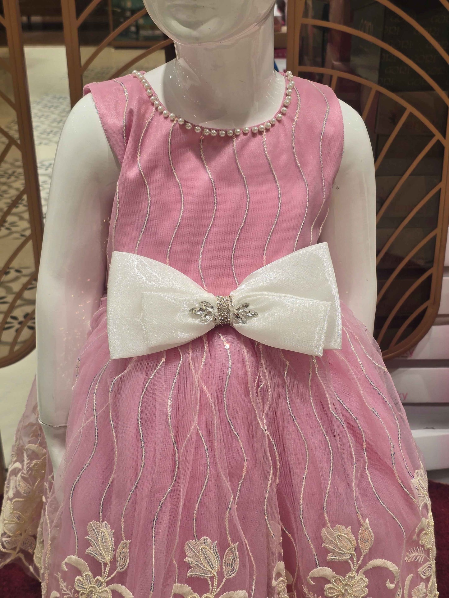 Knitted material baby pink coloured frock with elegant contrast white bow , embroidery with beats & sequence work over the body