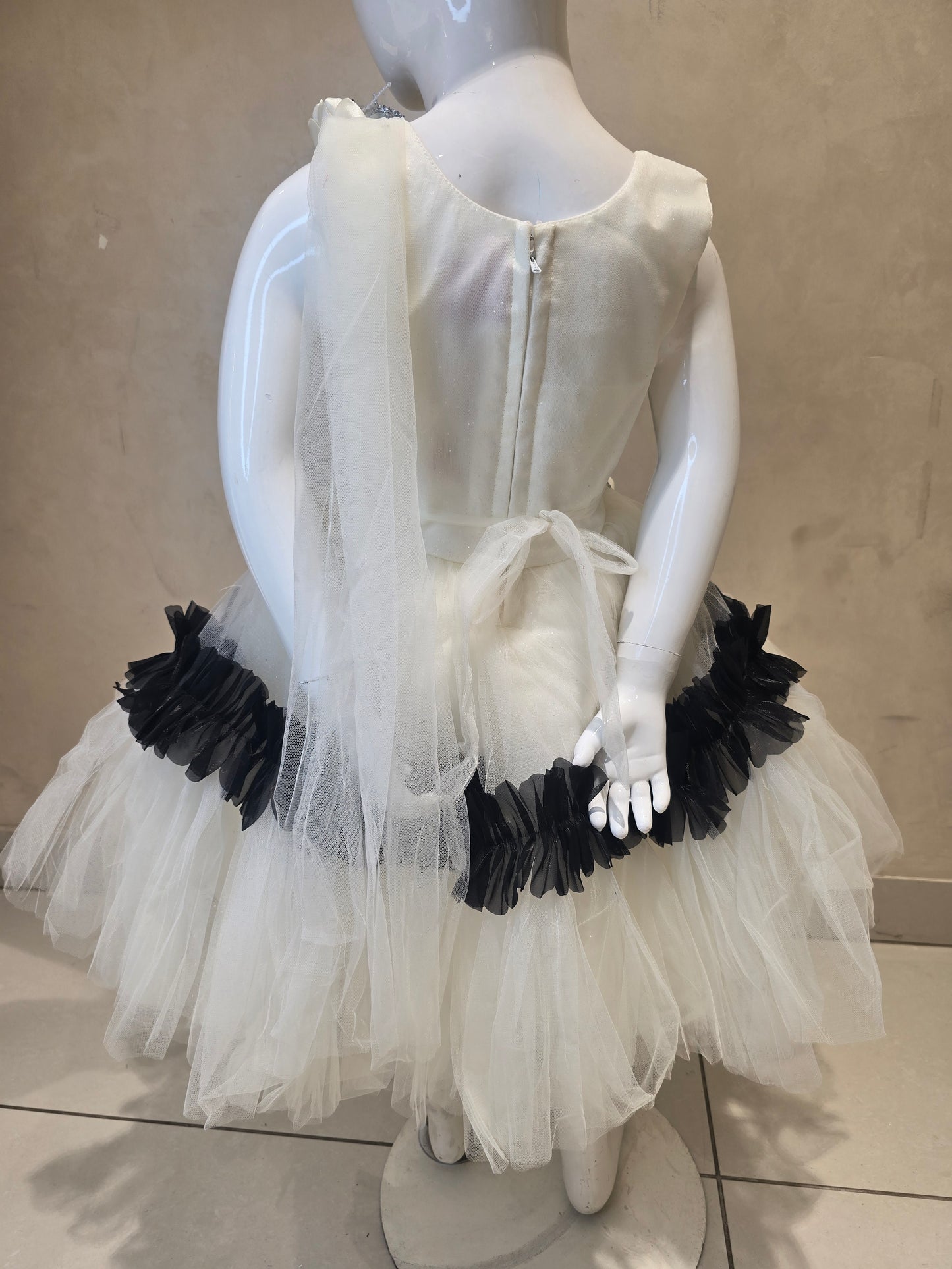 Girls Net Party Wear Short Frock in White and Black with Floral Brooch Waist Design and Round Neck for Special Occasions