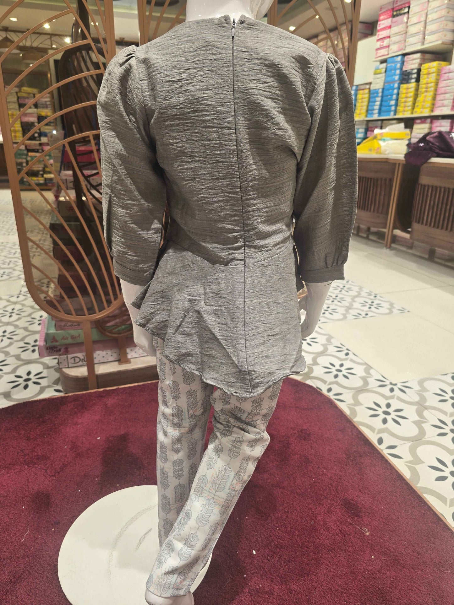 Span (stretchable) Material grey with printed white colour westren wear. The designer top has balloon sleeve and attachable tieing