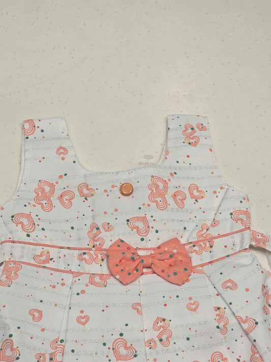 sleeveless cotton baby frock features an all-over heart print, making it perfect for everyday casual summer wear