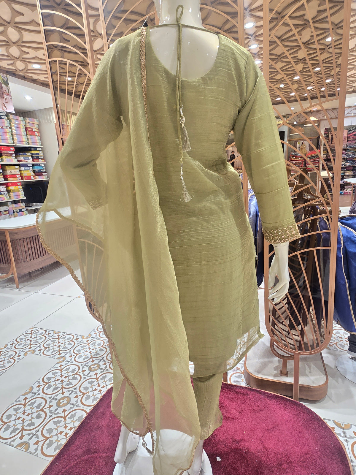 olive green ethnic salwar suit styled with subtle vertical shimmer stripes and delicate beadwork along the seams.
