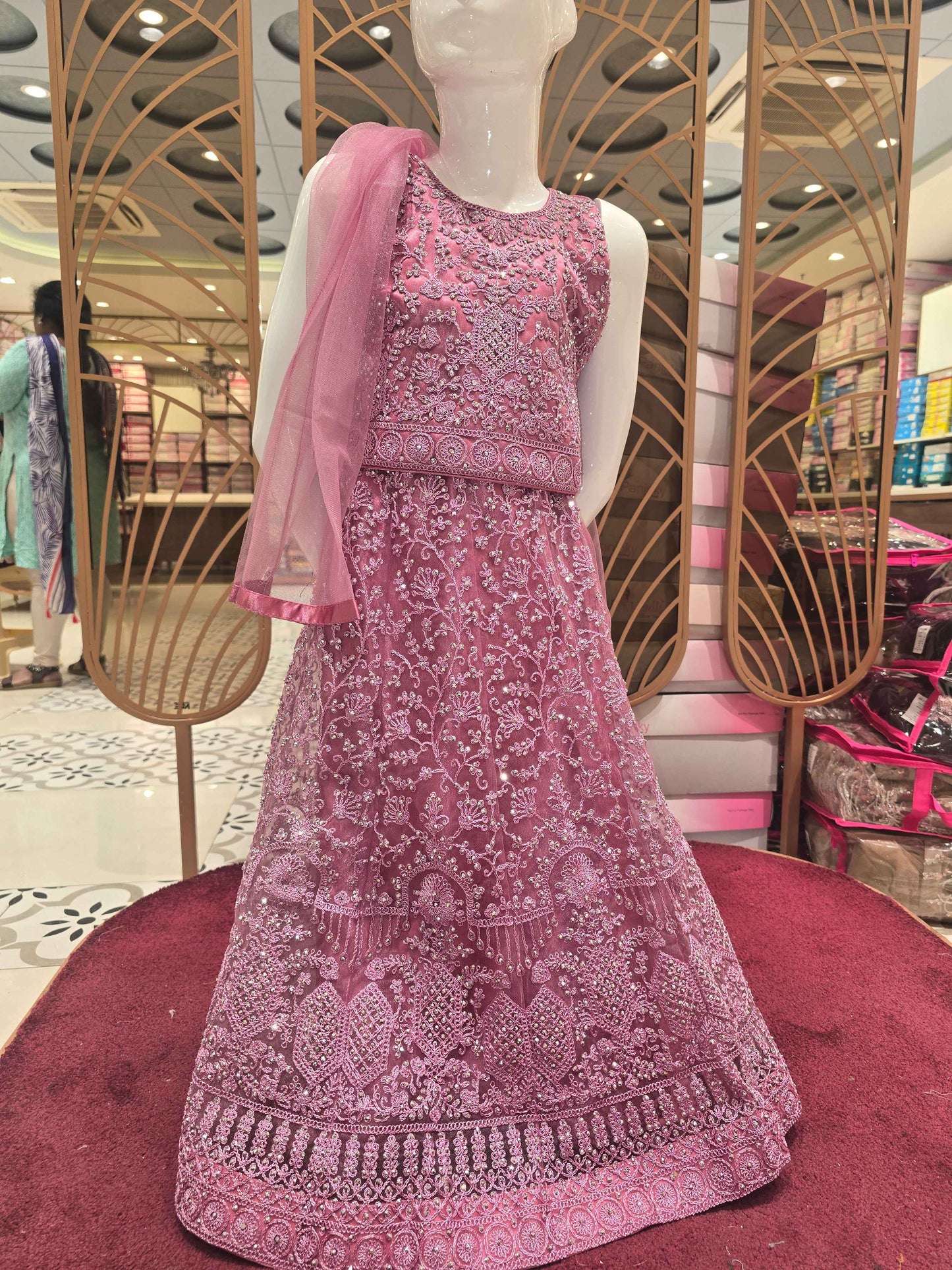 Knitted materail onion pink colour gaghra choli. Embroidery with stone fancy work on front side with round neck