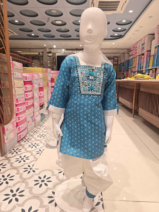 girls' ethnic salwar suit set, featuring a teal or sky-blue short printed kurti paired with white dhoti-style salwar pants