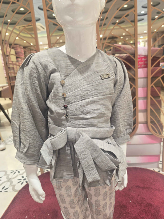 Span (stretchable) Material grey with printed white colour westren wear. The designer top has balloon sleeve and attachable tieing