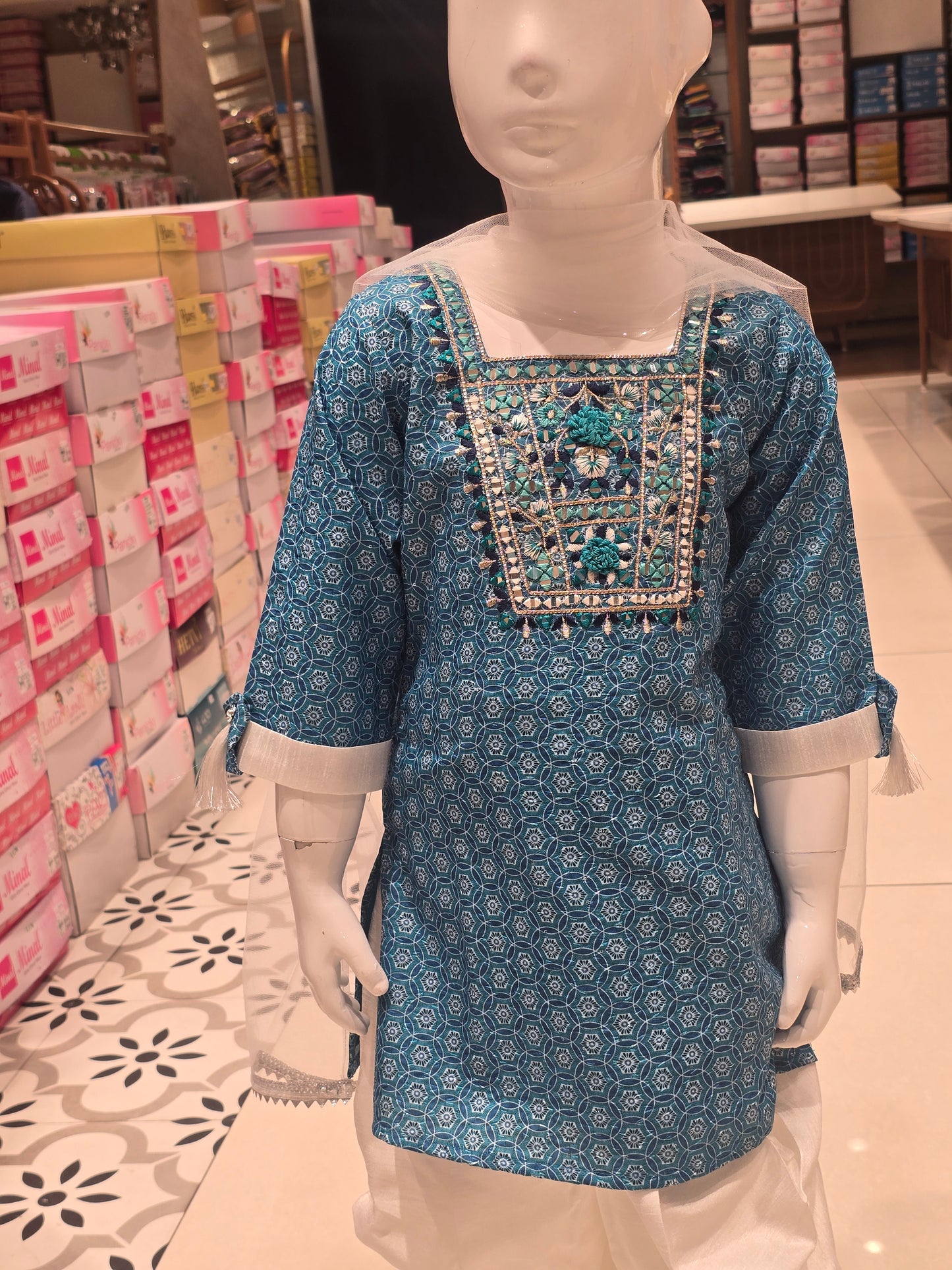 girls' ethnic salwar suit set, featuring a teal or sky-blue short printed kurti paired with white dhoti-style salwar pants