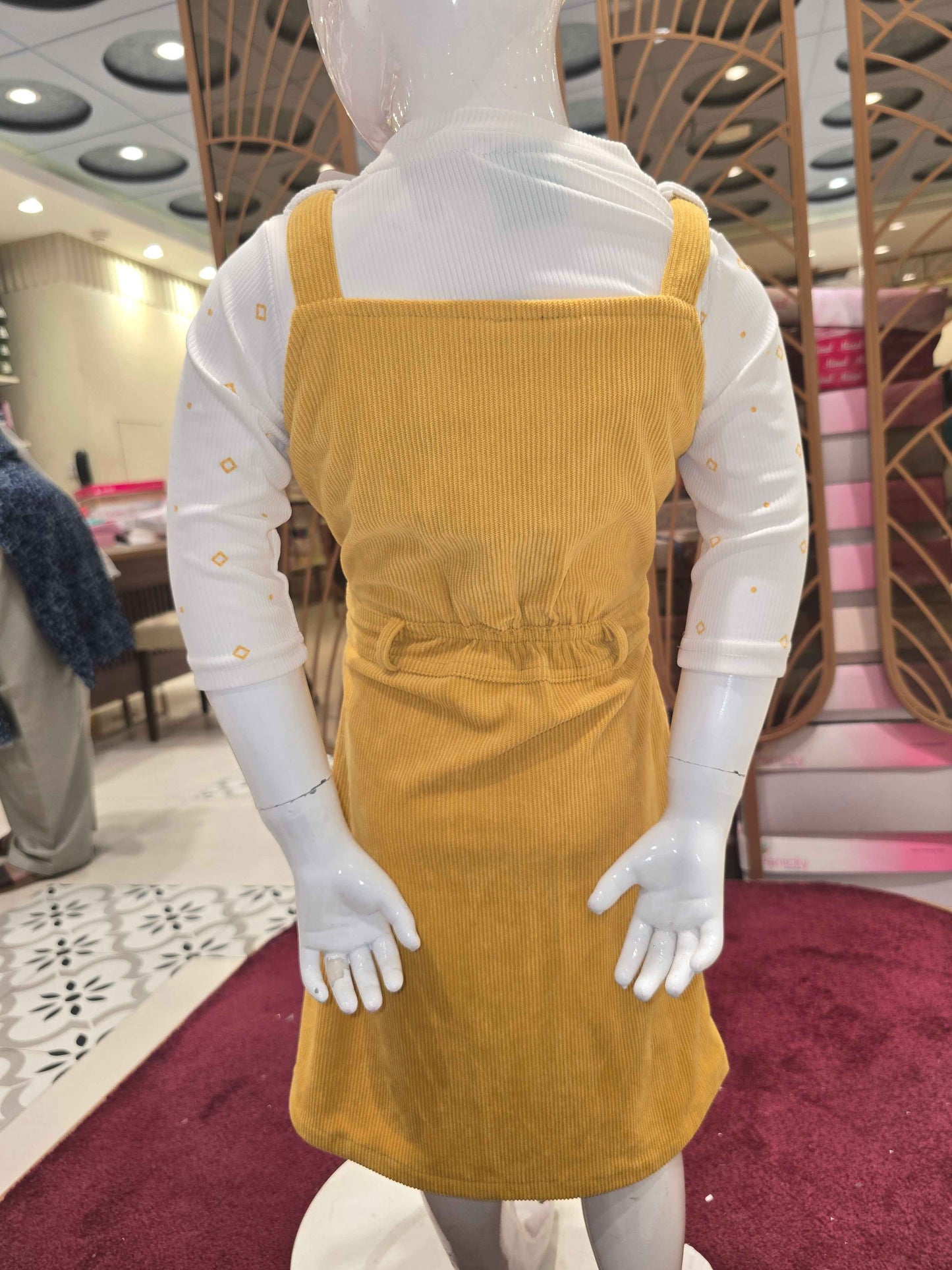 Corduroy material mustred with white colour dangri frock with tieing and 2 pockets