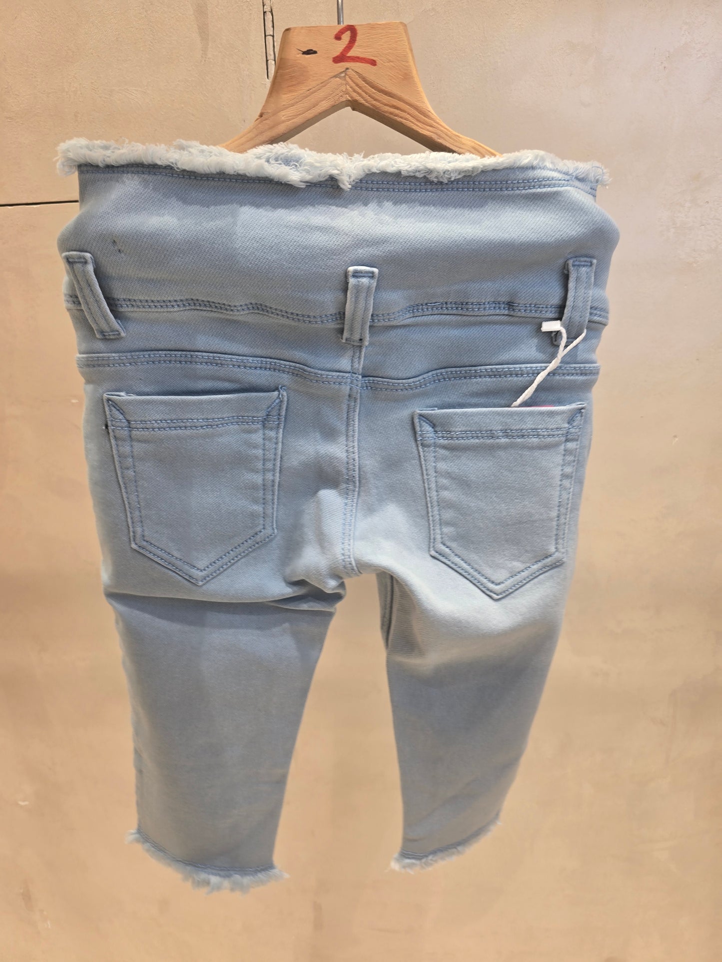 Sky blue colored denim jeans capri pant with 3 button and waist thread-cut design