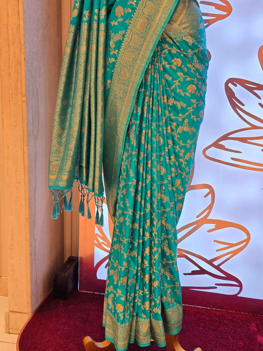 traditional turquoise Banarasi silk saree featuring intricate gold zari floral vines and a broad,