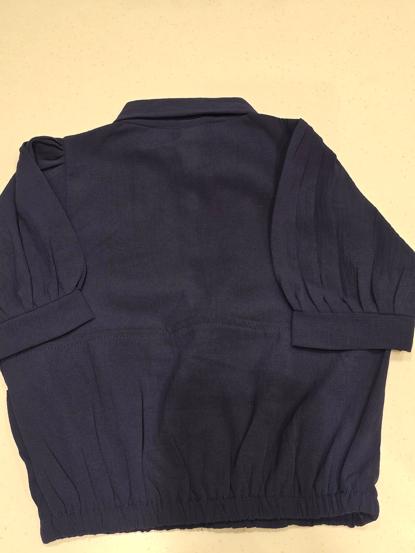 navy blue cropped polo top with a drawstring hem
