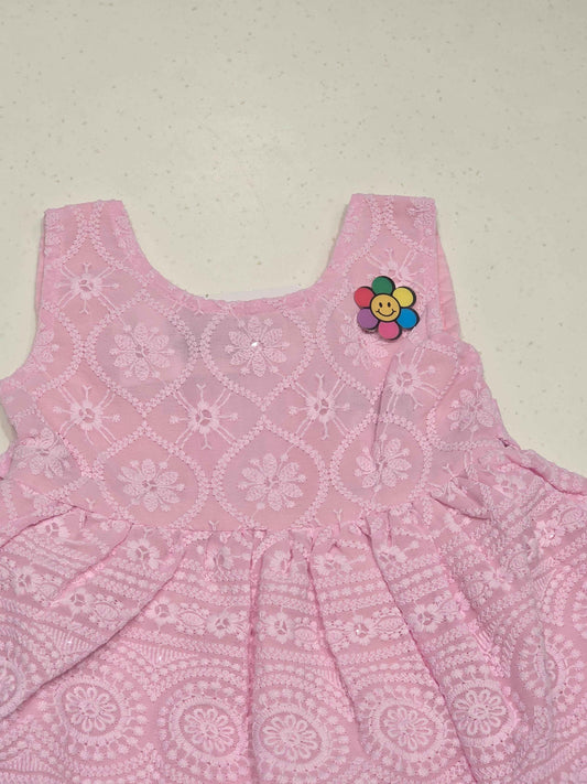 baby girl's cotton frock in a soft pastel pink shade.