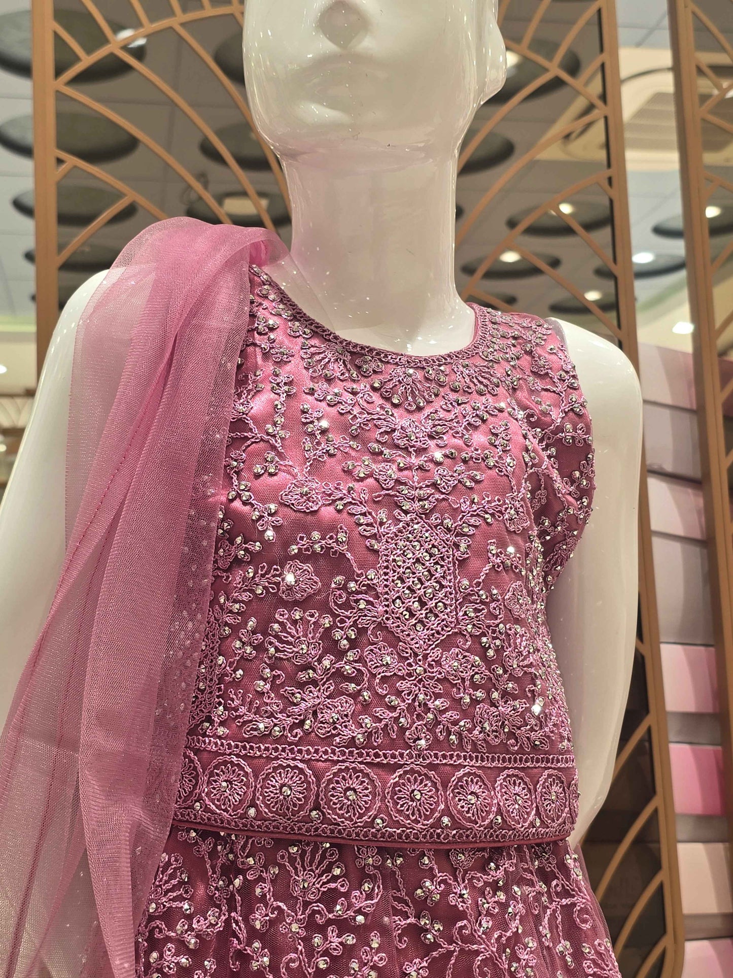 Knitted materail onion pink colour gaghra choli. Embroidery with stone fancy work on front side with round neck