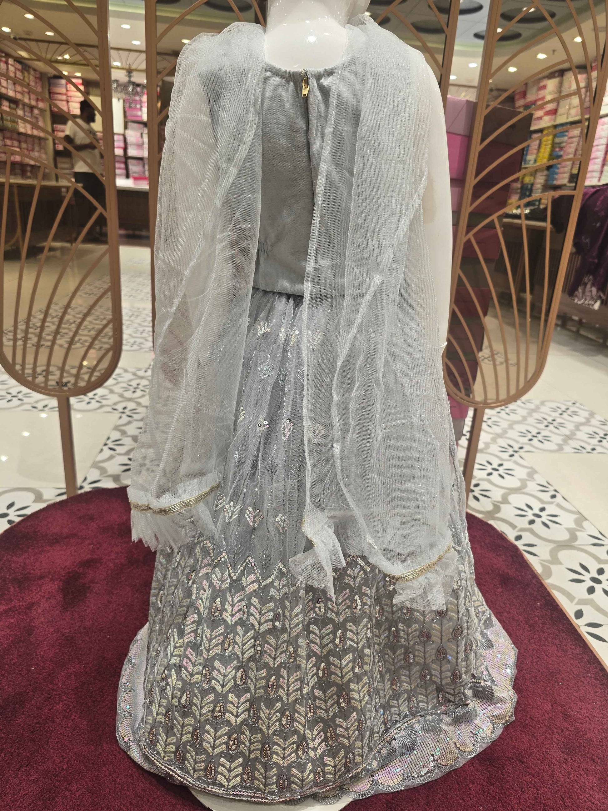 Knitted material silver colour bridal wear with sequence work over the body with silver embroidery. Dupatta with fril border