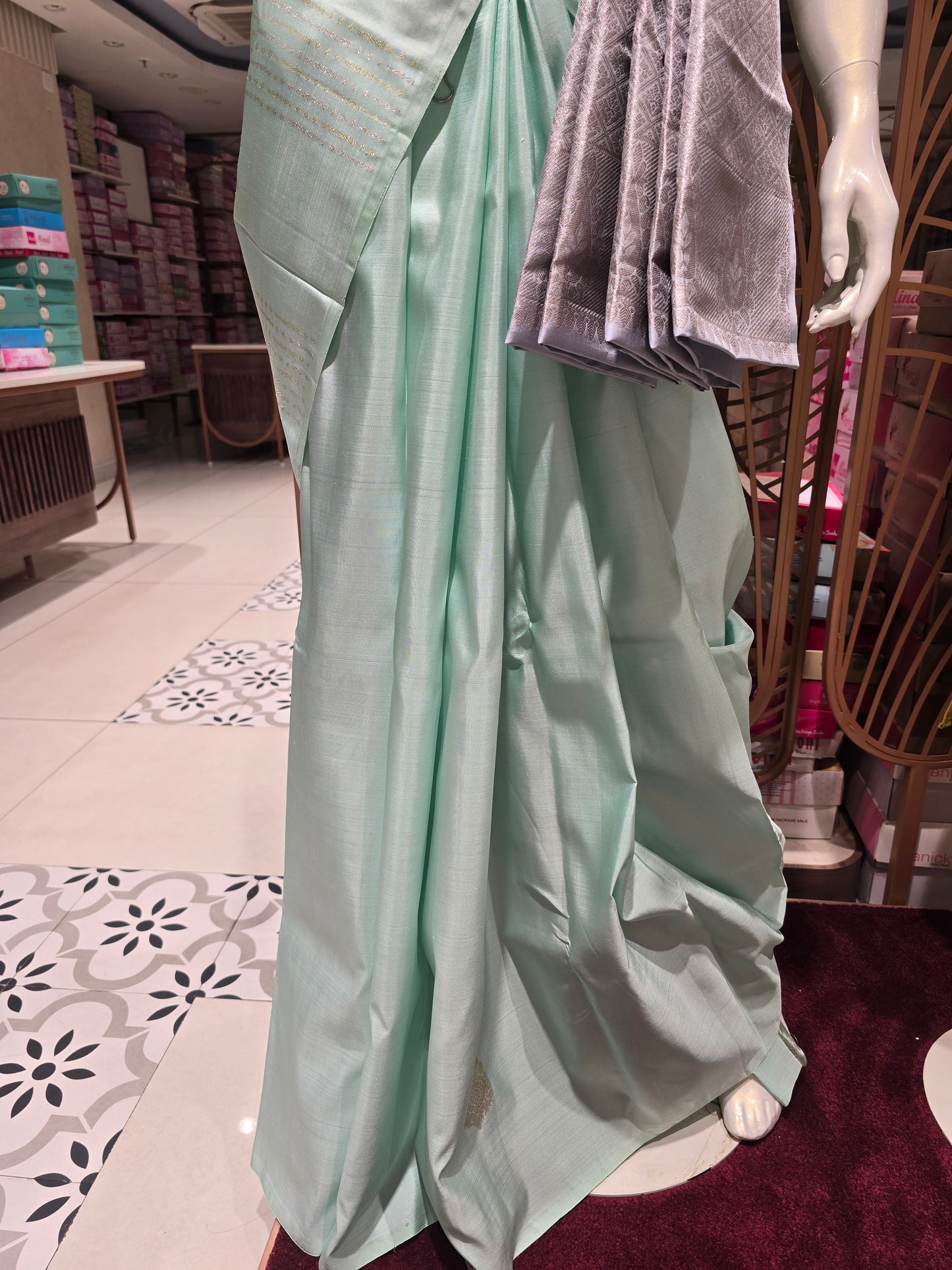 pastel mint green traditional silk saree styled with a contemporary contrasting lavender-grey fabric waist belt (kammarbandh) and an elegant,