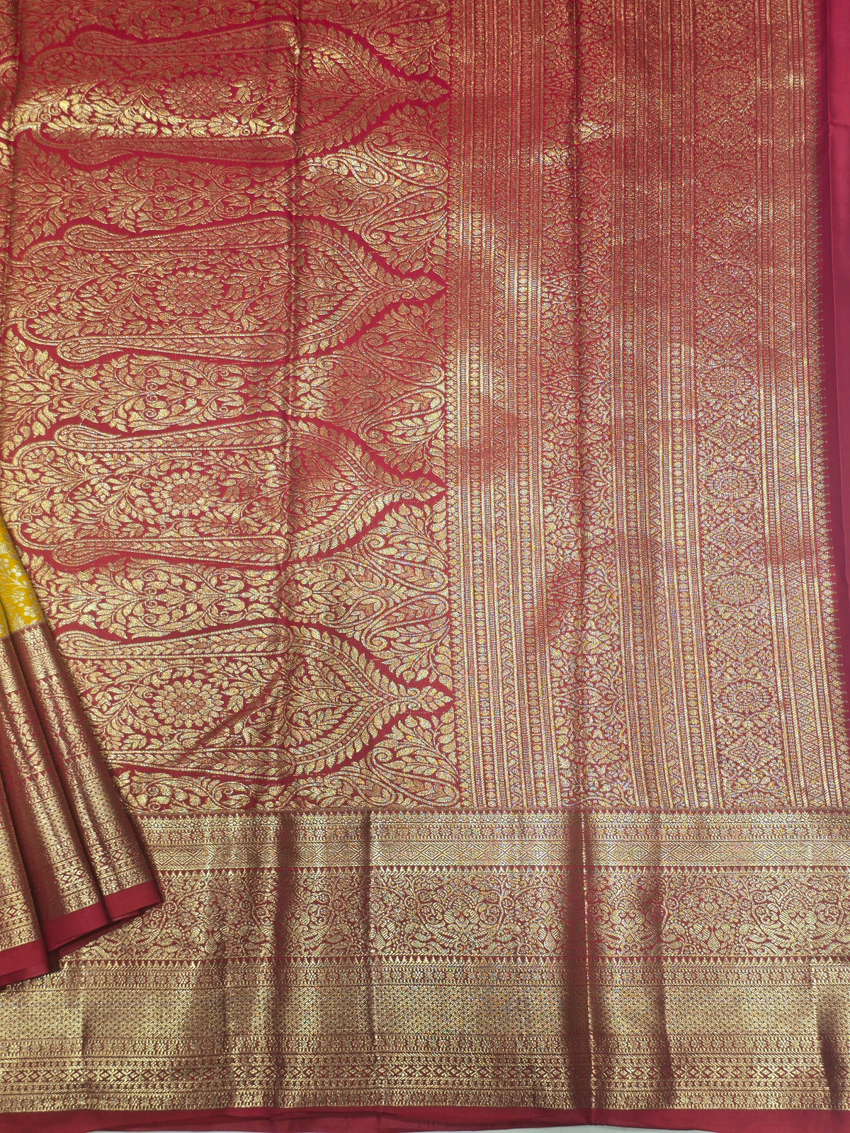 yellow and pink Kanchipuram style semi-silk saree adorned with elegant zari floral patterns and a broad contrast border.