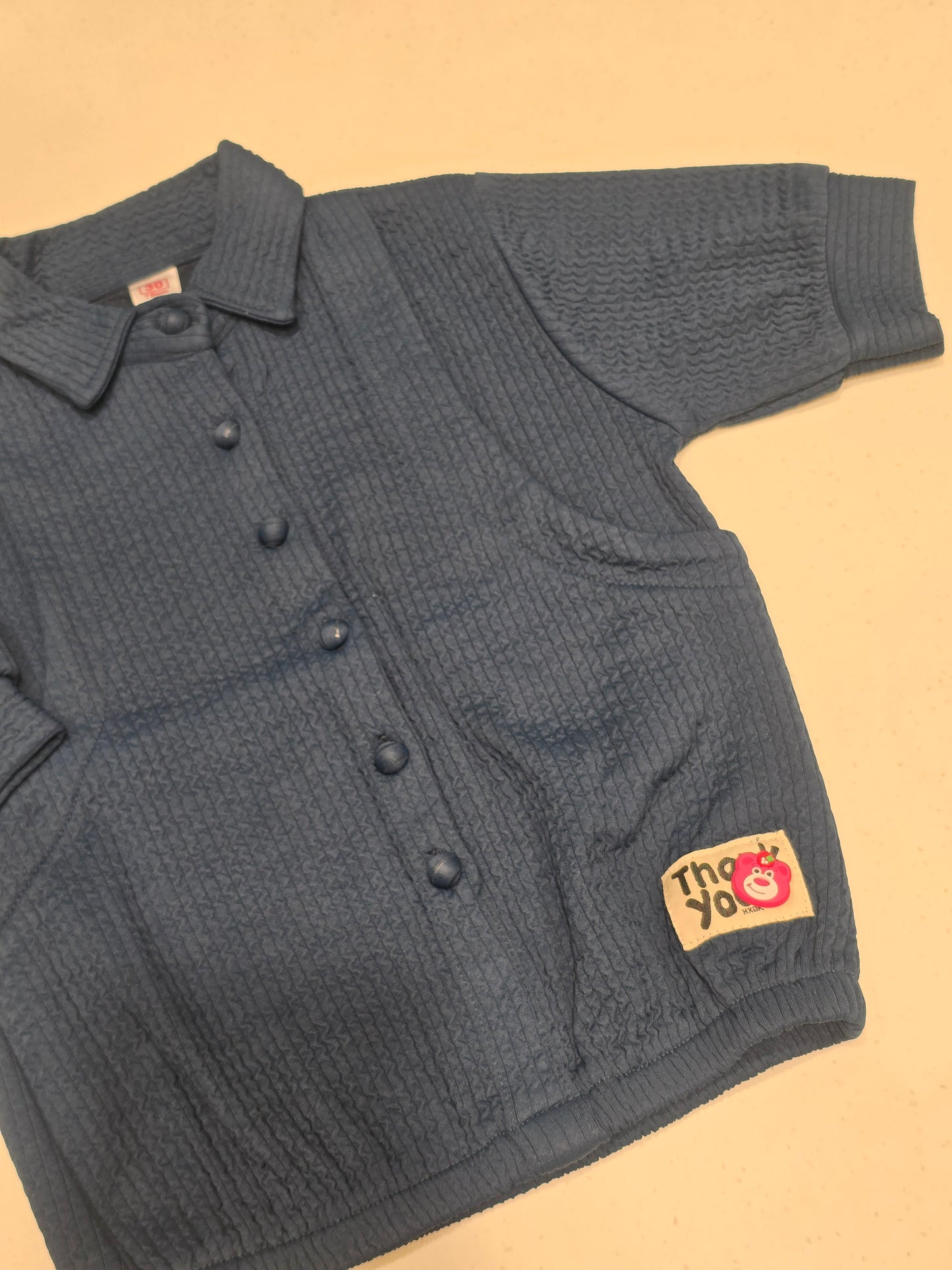 dark blue, smocked or waffle-textured kids' casual shirt