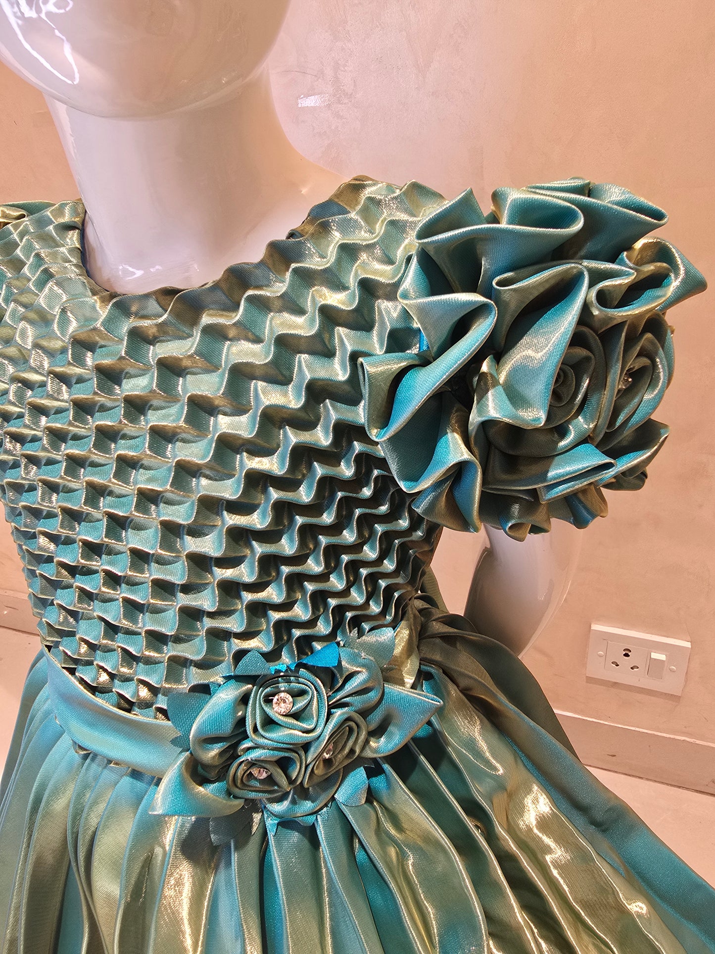 Shining Satin material green colored short frock with cold buff Sleeves , attached waist flower design