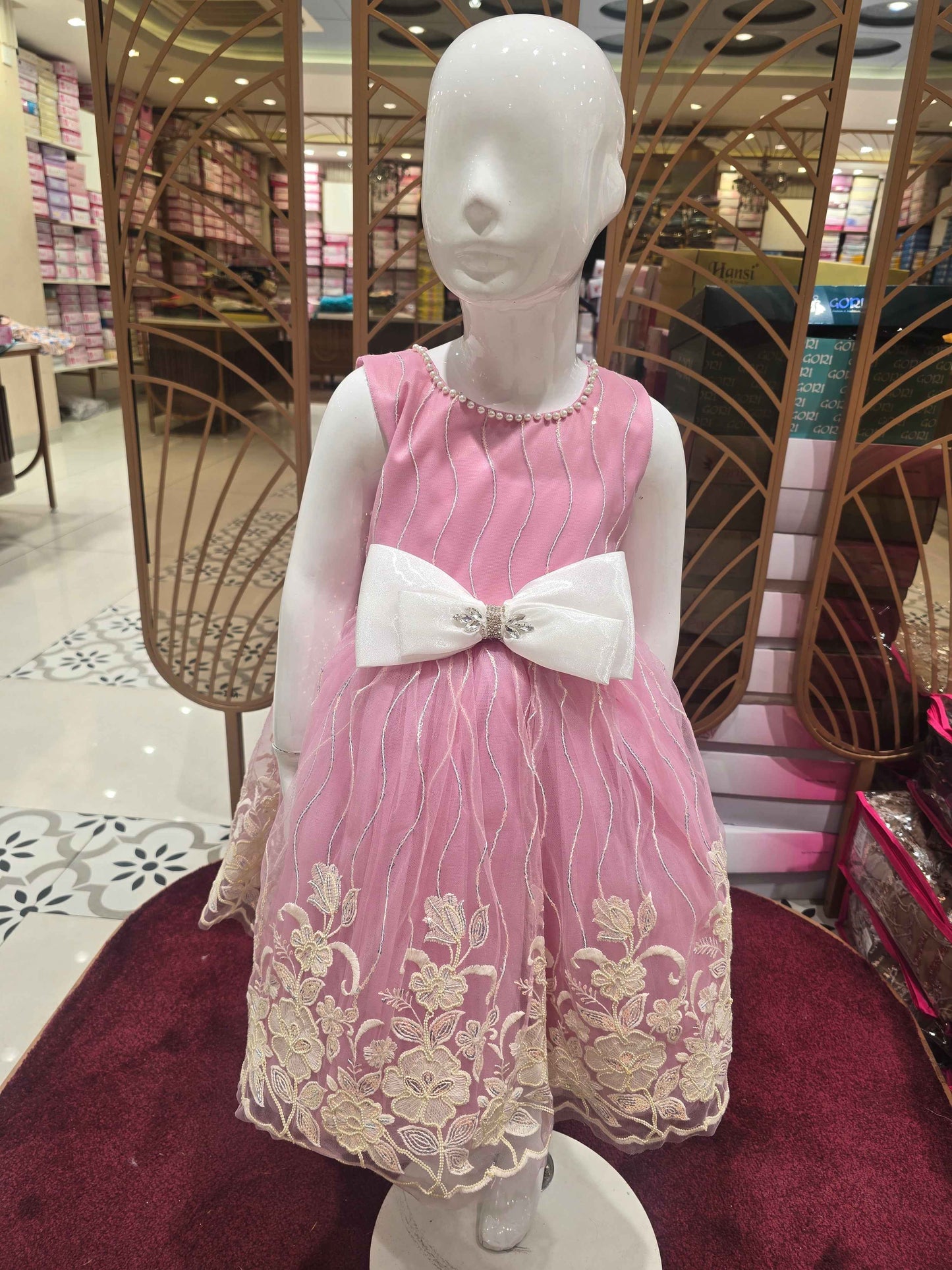 Knitted material baby pink coloured frock with elegant contrast white bow , embroidery with beats & sequence work over the body