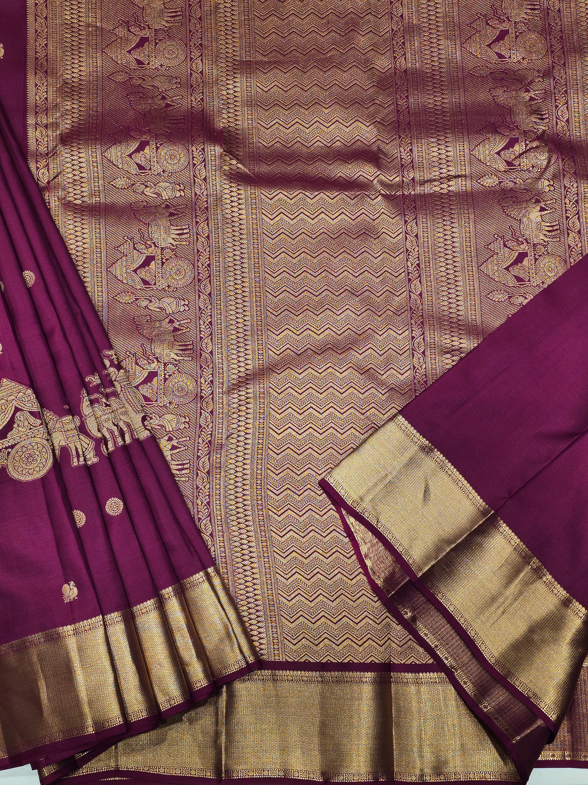 One saree is a deep royal purple, and the other is a rich magenta/wine tone.