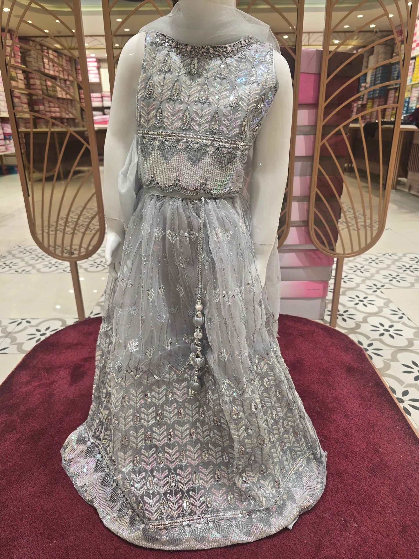 Knitted material silver colour bridal wear with sequence work over the body with silver embroidery. Dupatta with fril border