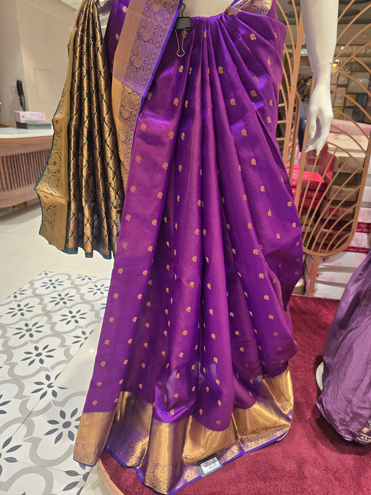 traditional Indian attire renowned for its rich color and intricate golden zari work.