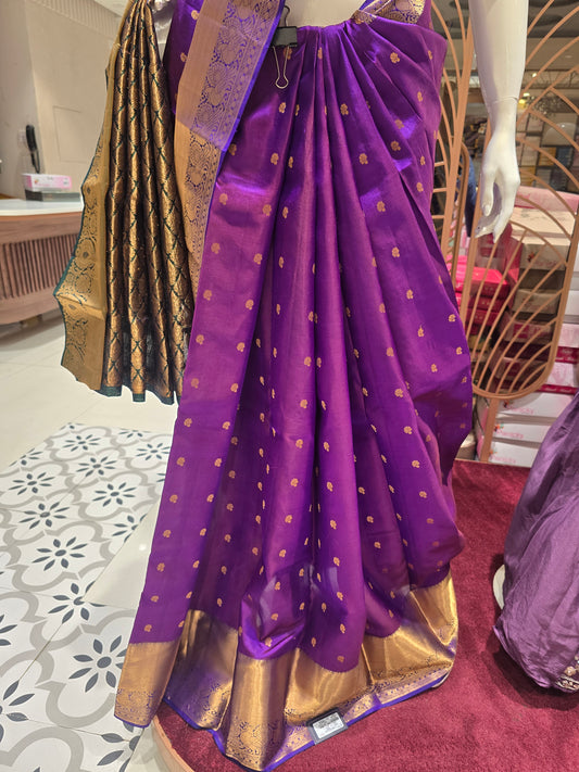 traditional Indian attire renowned for its rich color and intricate golden zari work.