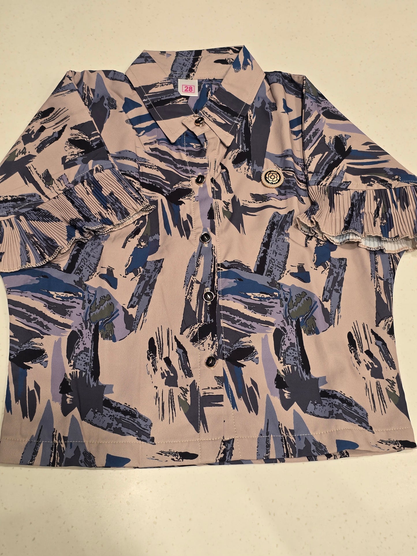 girls' casual short-sleeve shirt featuring a distinctive abstract brushstroke print in shades of blue, grey, and khaki on a beige base