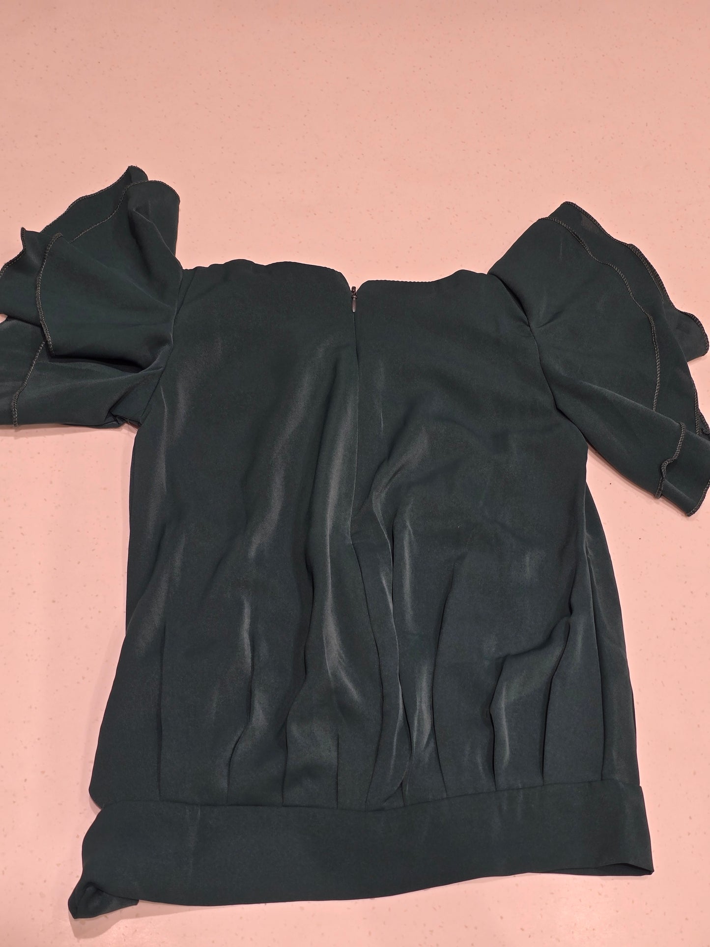 dark green girl's party top featuring short, ruffled butterfly sleeves and an elasticated bottom hem with a matching side tie-up sash