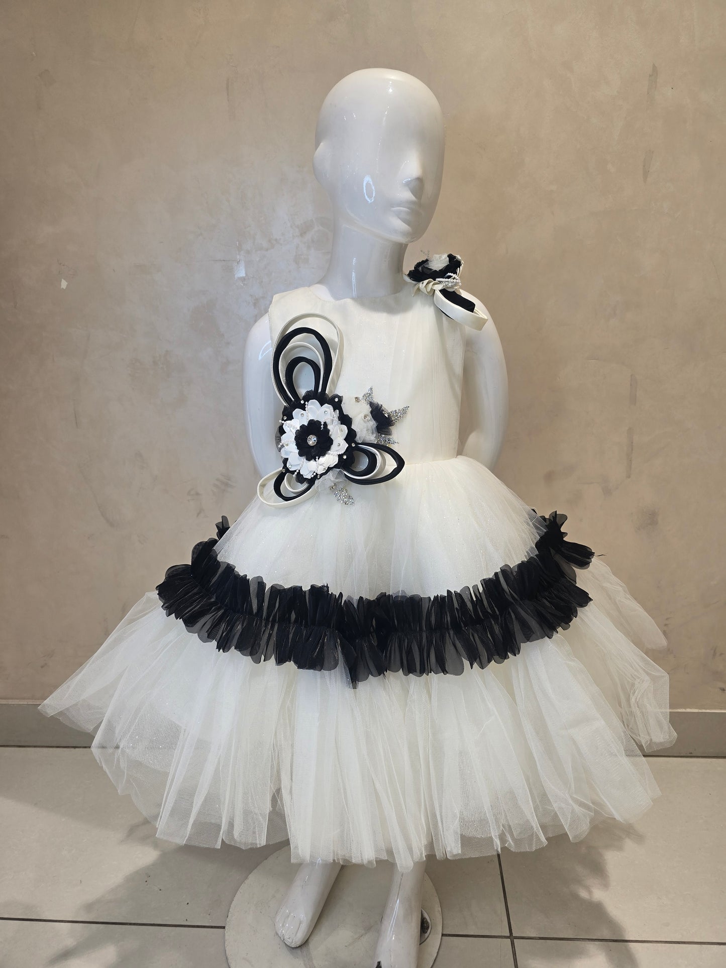 Girls Net Party Wear Short Frock in White and Black with Floral Brooch Waist Design and Round Neck for Special Occasions