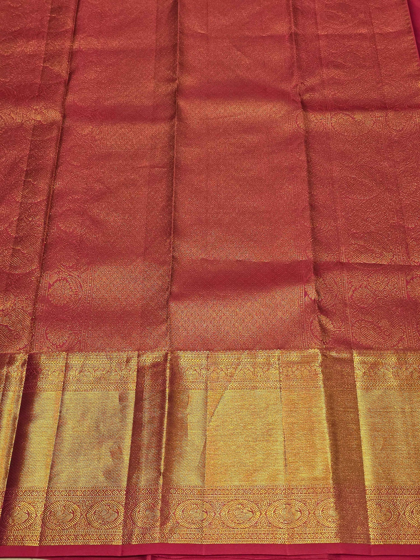 Pure handloom kanjivaram brocade Rani pink coloured silk saree with golden fancy design over the body and rich pallu