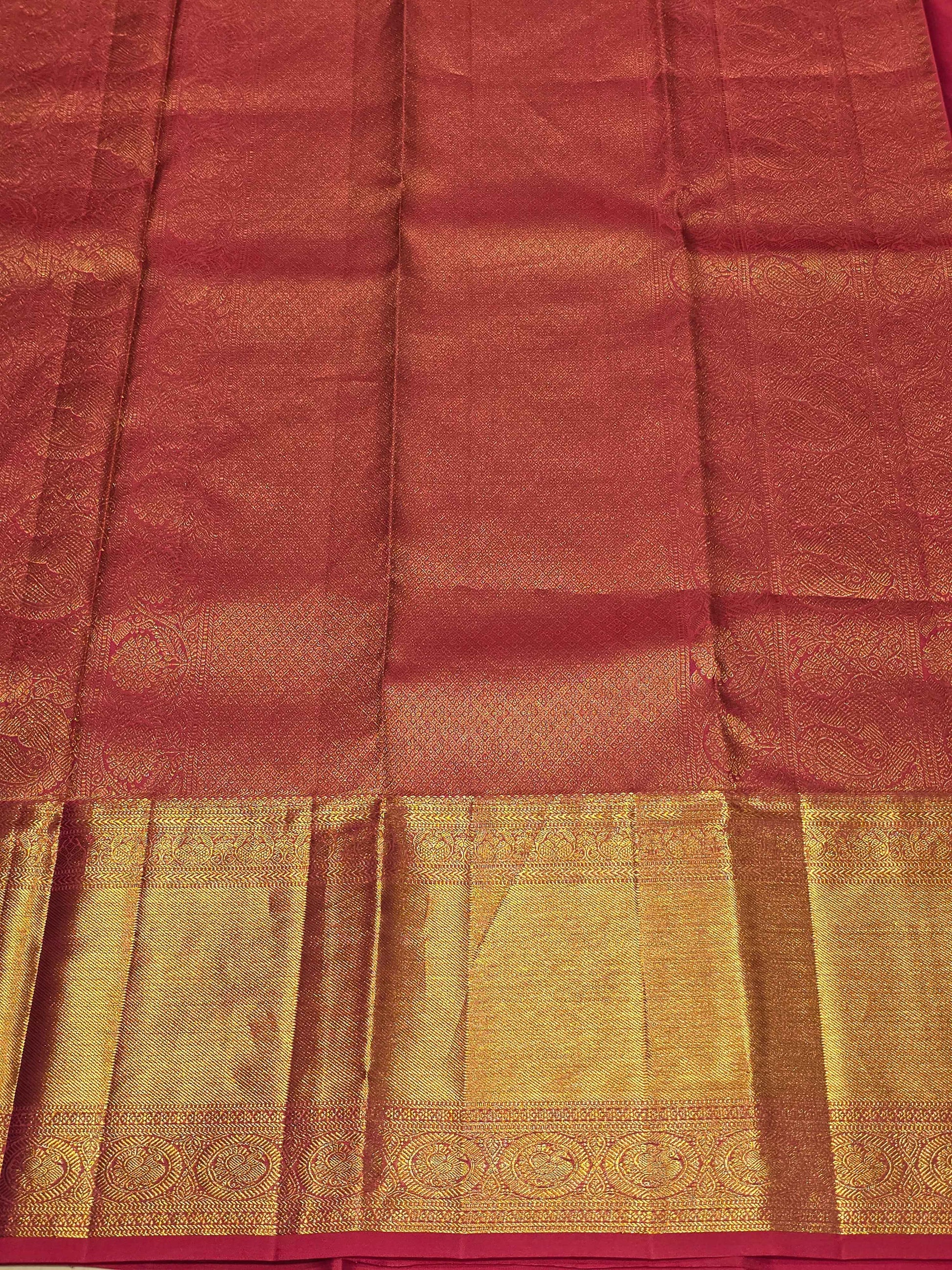 Pure handloom kanjivaram brocade Rani pink coloured silk saree with golden fancy design over the body and rich pallu