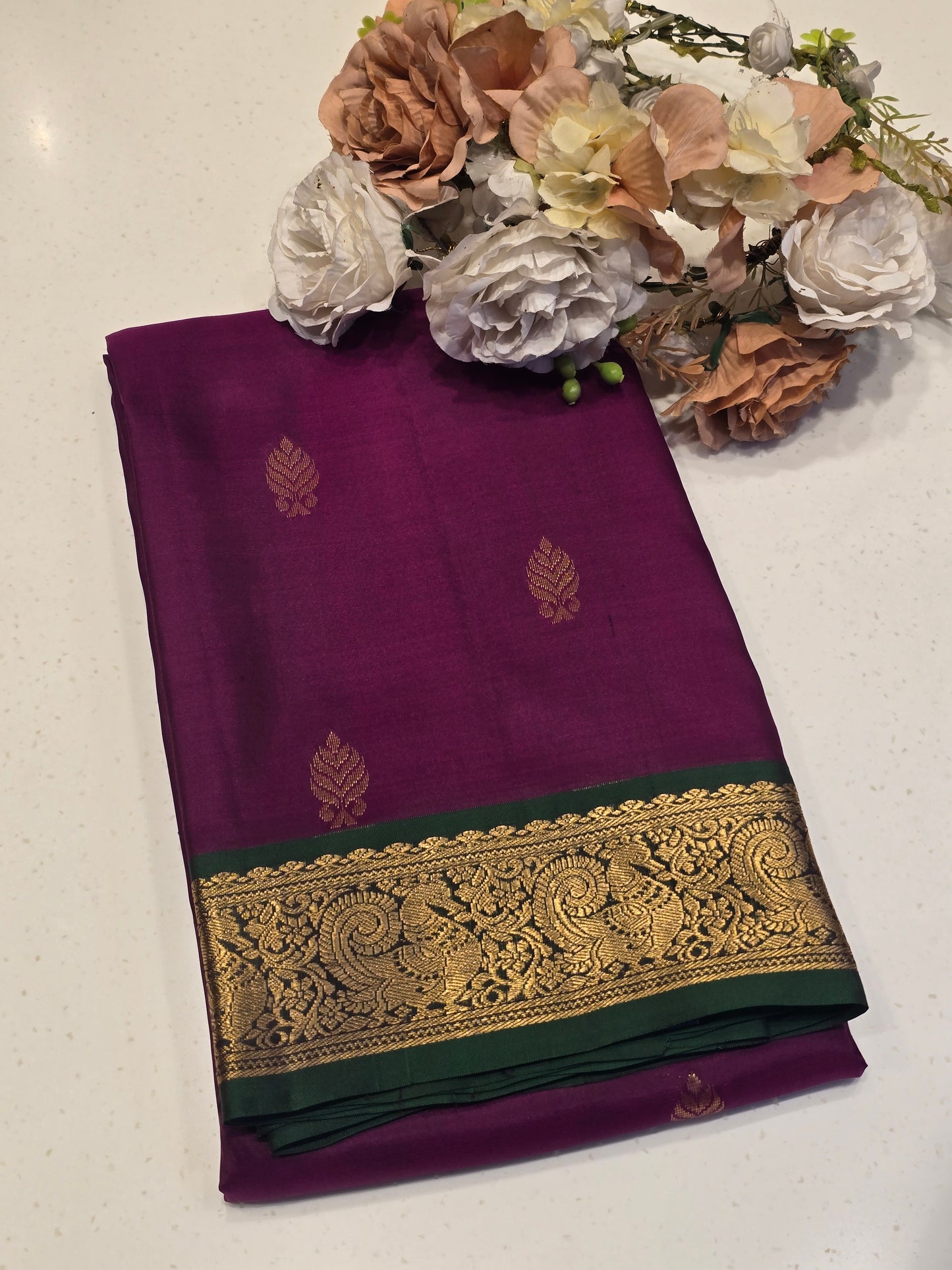 Handloom pure Kanjivaram silk with small leaf styled motifs and small traditional peacock designed border, rich pallu