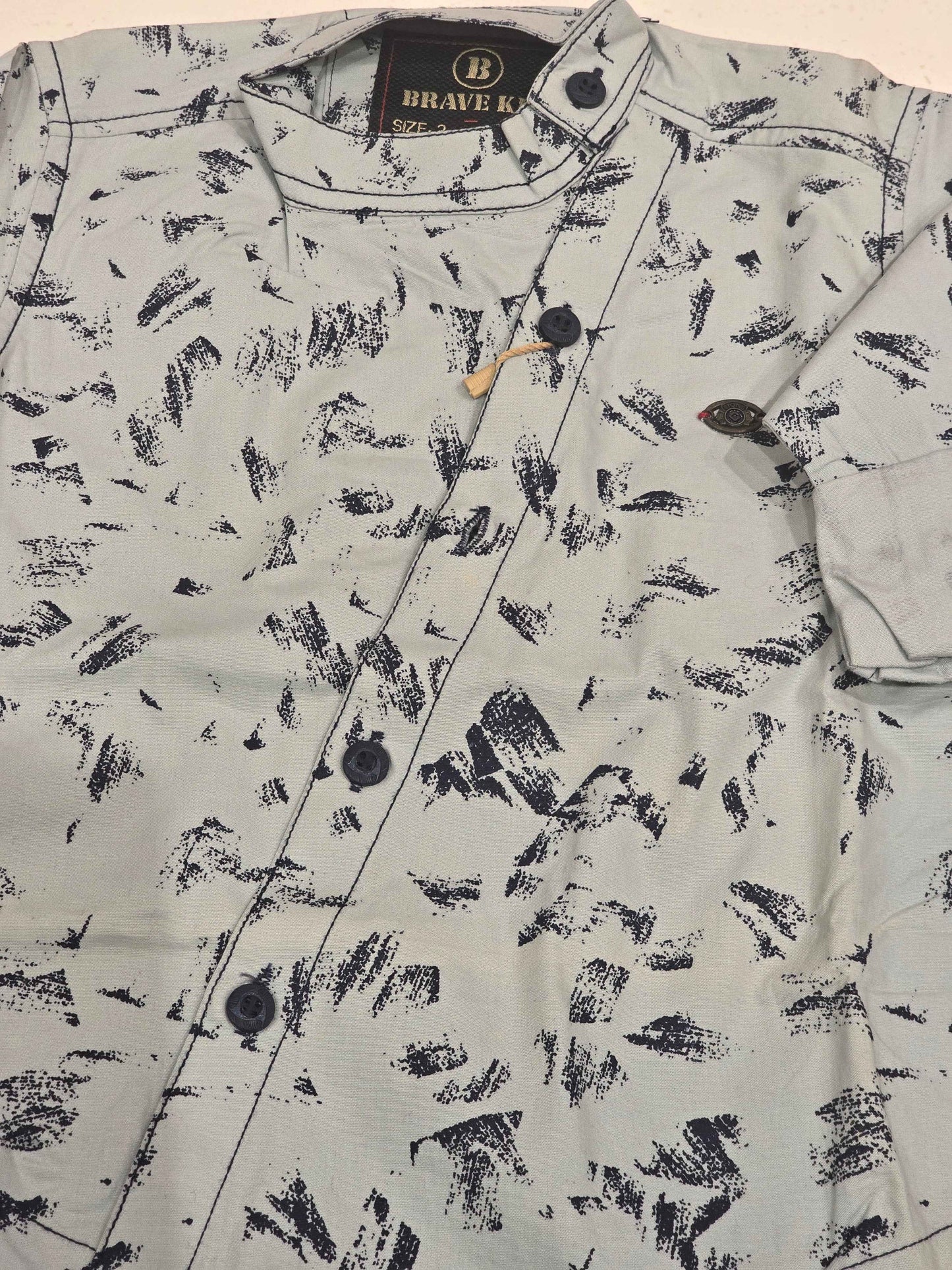 Cotton material white based wuth black printed shirt for boy