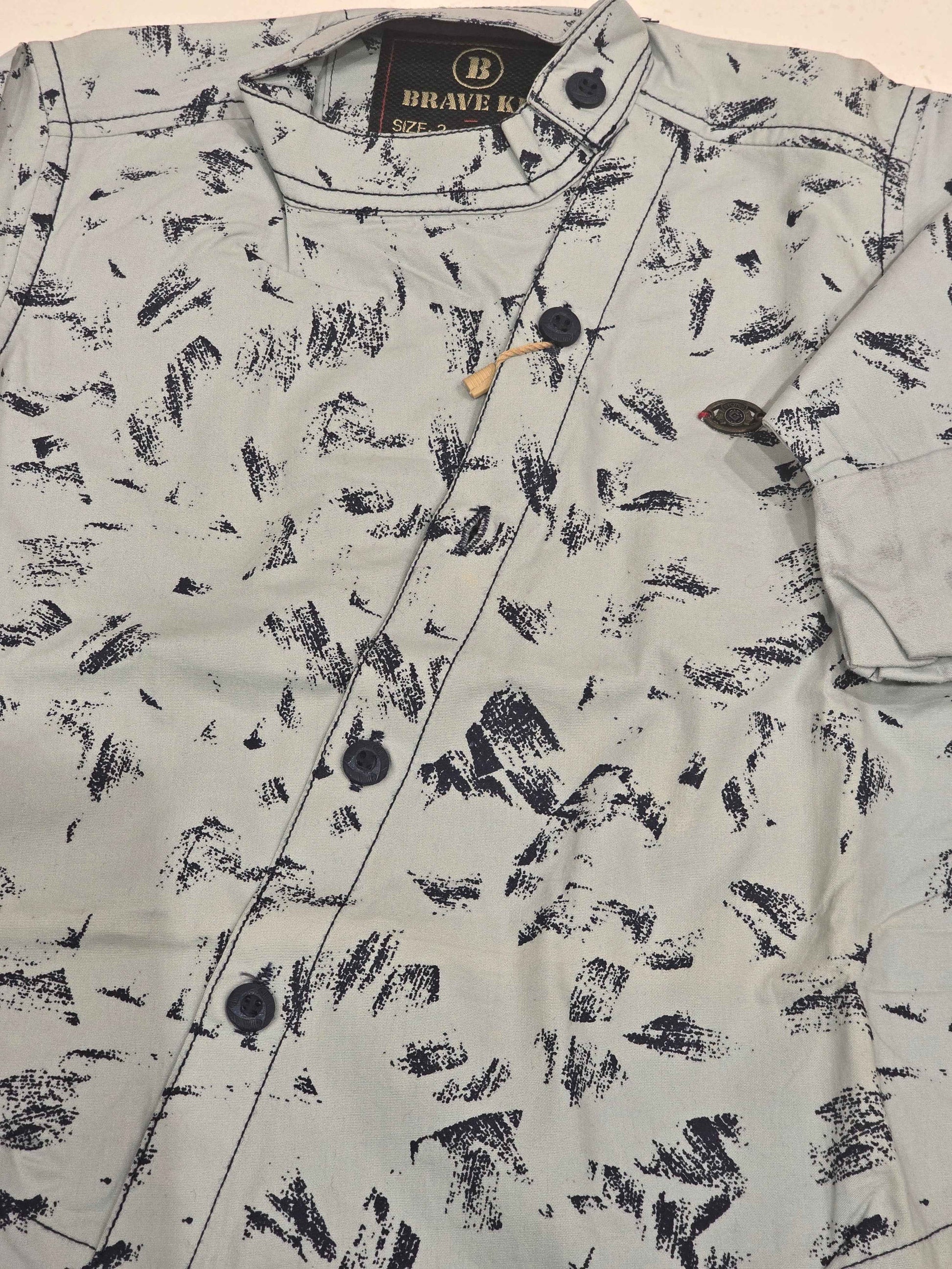 Cotton material white based wuth black printed shirt for boy
