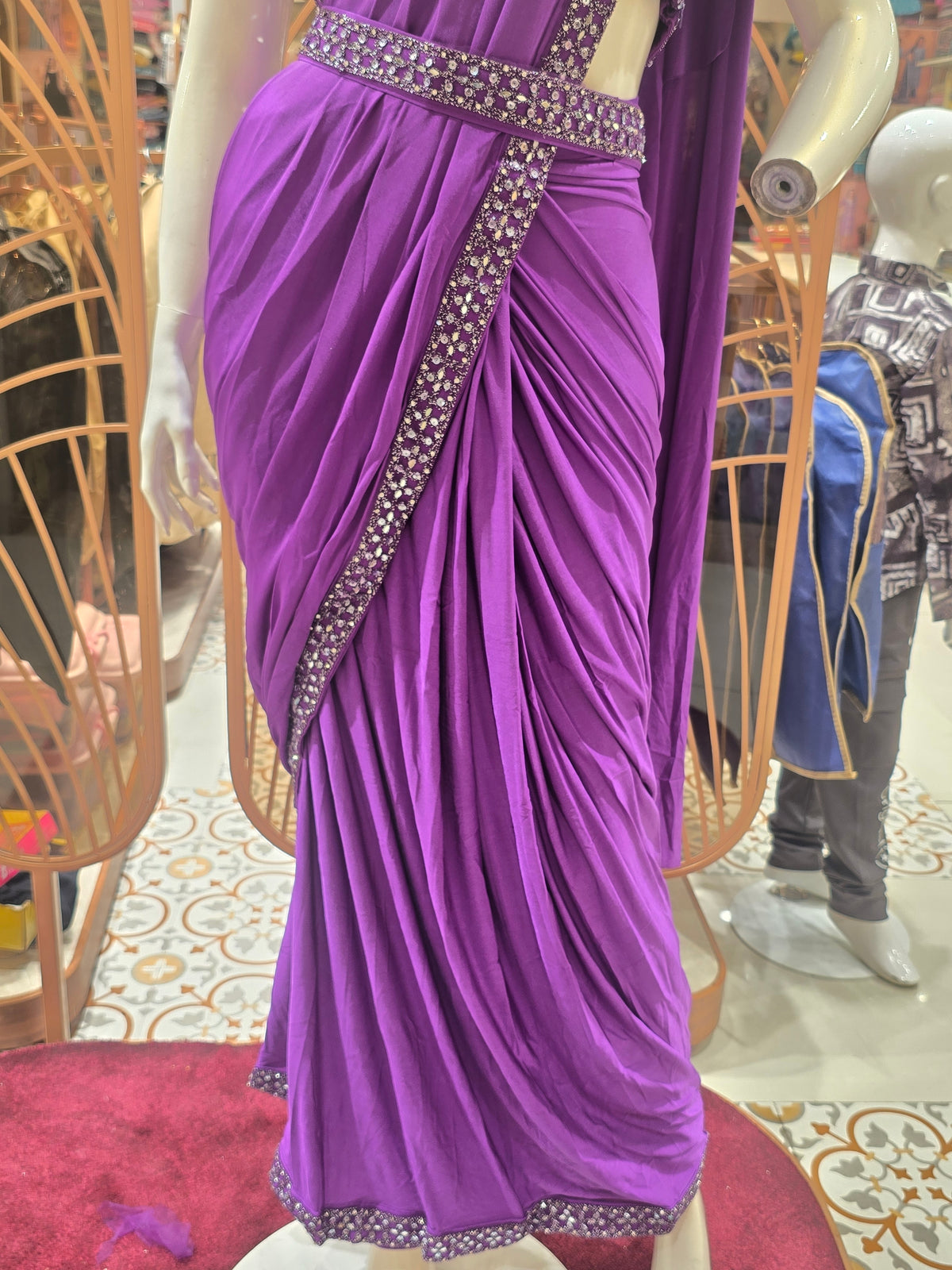 purple ready-to-wear pre-stitched saree crafted with a sleek, draping fabric like Lycra or satin crepe.