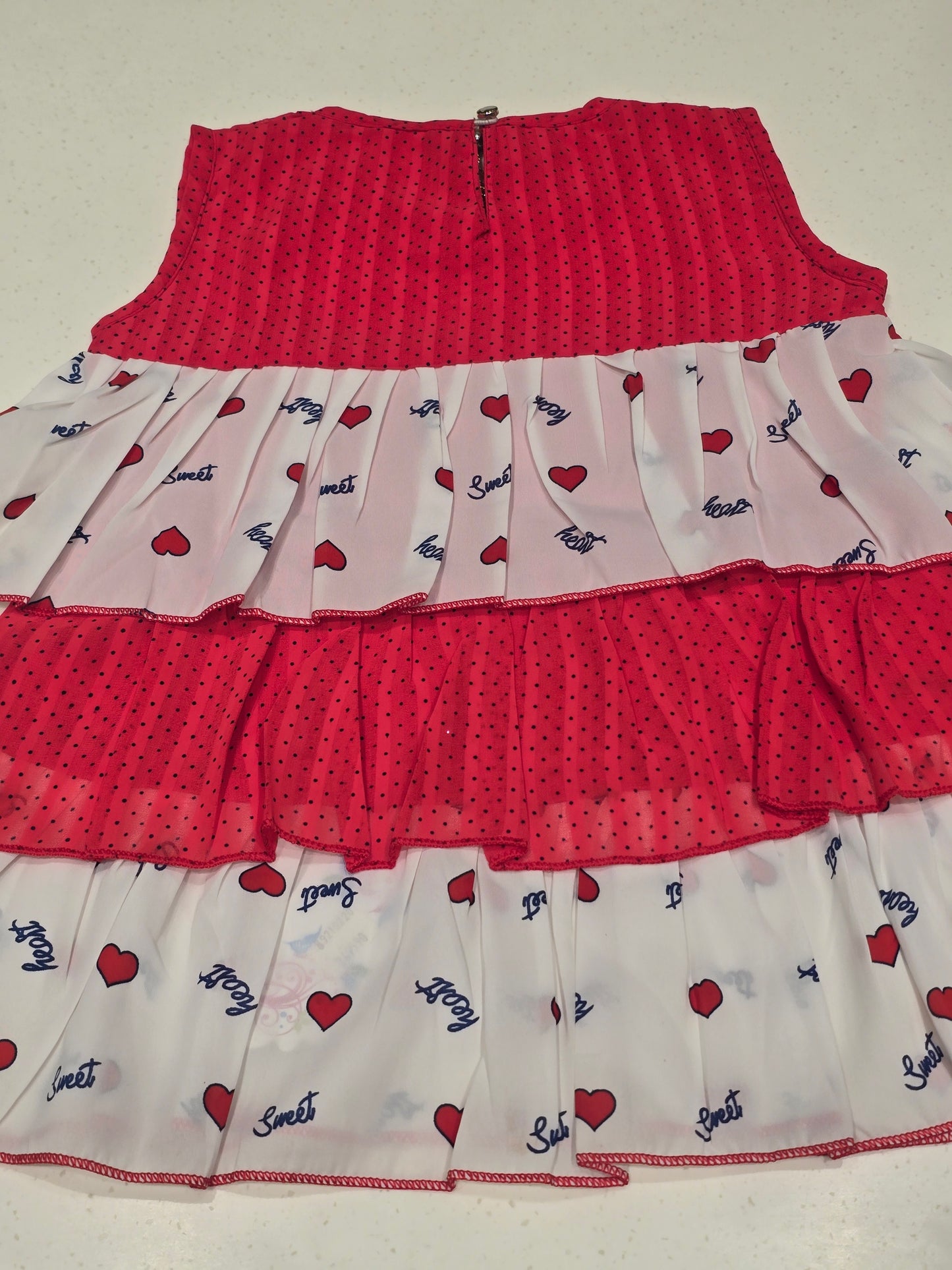 kids' tiered frill dress featuring alternating horizontal layers of patterned fabric.