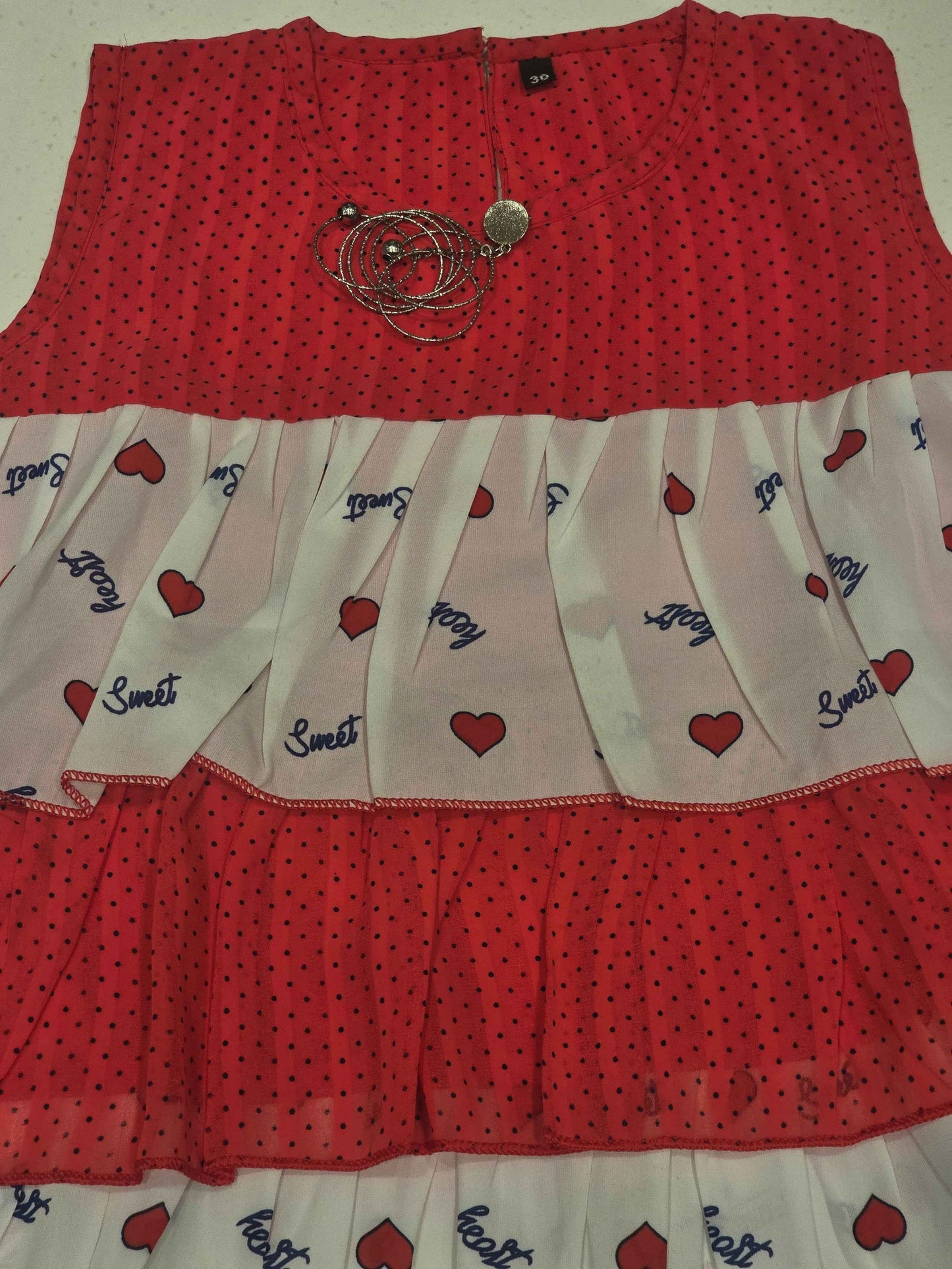kids' tiered frill dress featuring alternating horizontal layers of patterned fabric.