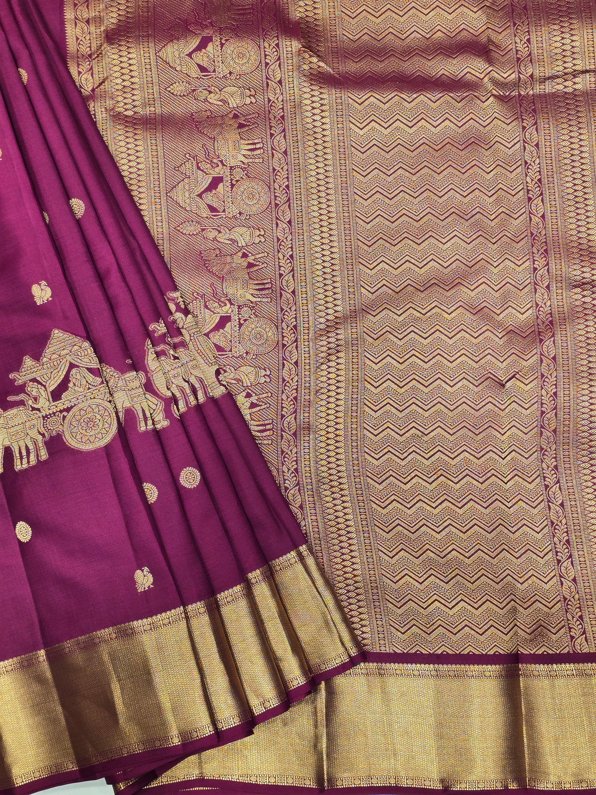 One saree is a deep royal purple, and the other is a rich magenta/wine tone.