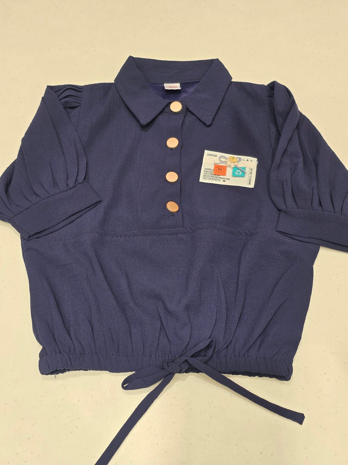 navy blue cropped polo top with a drawstring hem