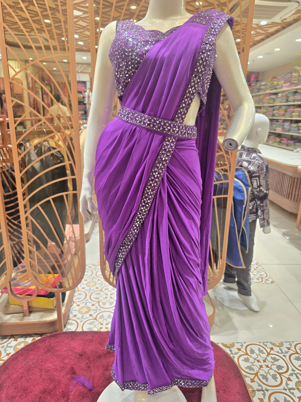 purple ready-to-wear pre-stitched saree crafted with a sleek, draping fabric like Lycra or satin crepe.