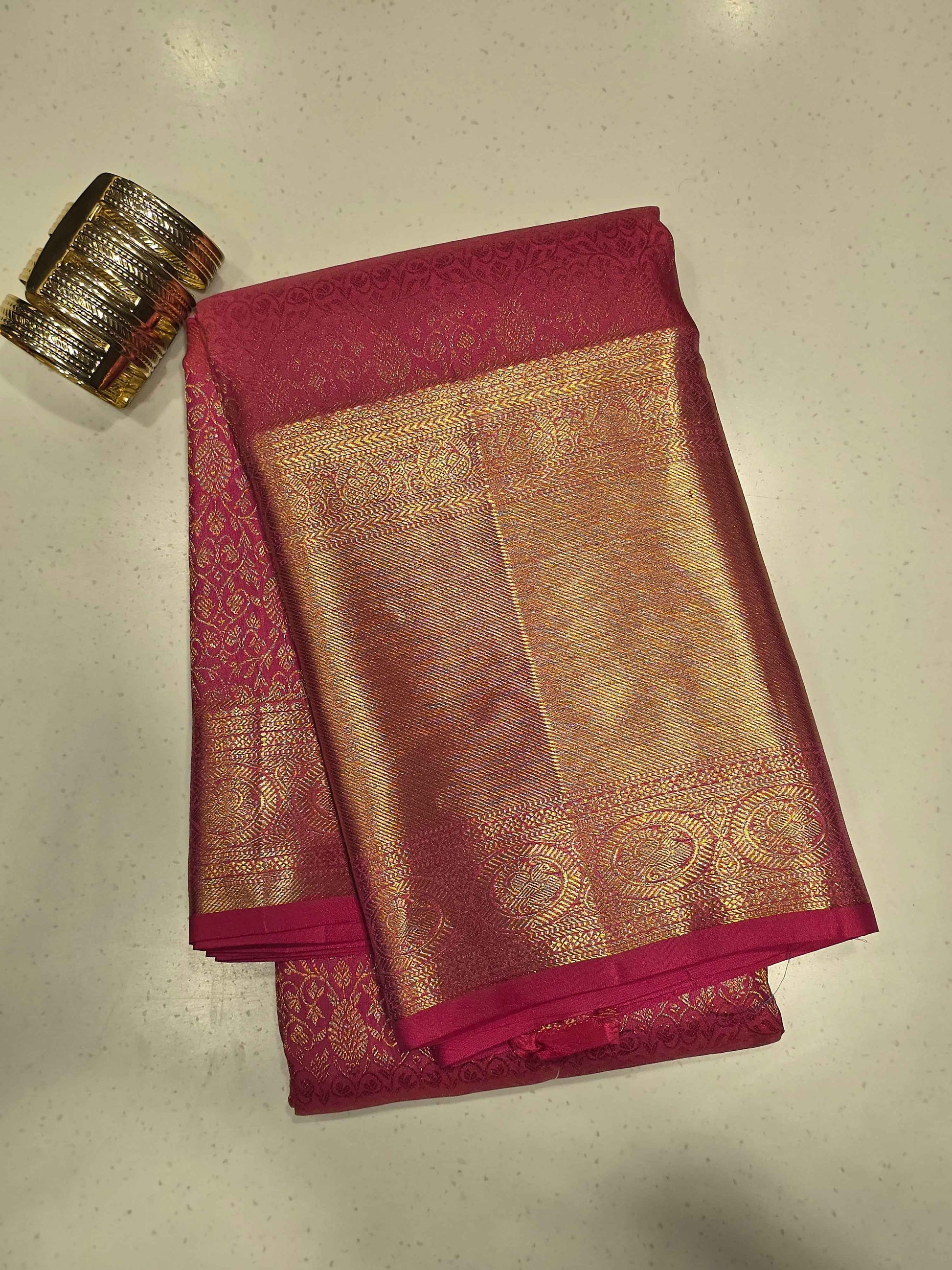 Pure handloom kanjivaram brocade Rani pink coloured silk saree with golden fancy design over the body and rich pallu