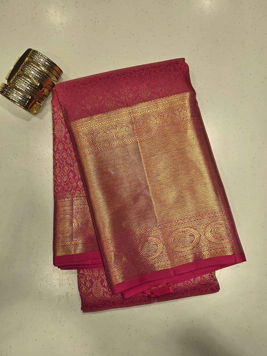 Pure handloom kanjivaram brocade Rani pink coloured silk saree with golden fancy design over the body and rich pallu