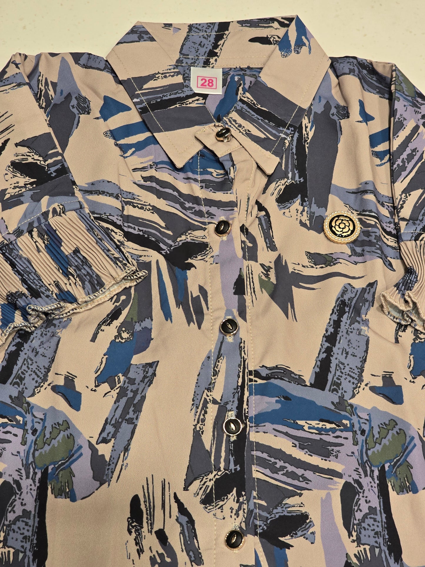 girls' casual short-sleeve shirt featuring a distinctive abstract brushstroke print in shades of blue, grey, and khaki on a beige base