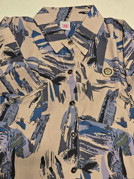 girls' casual short-sleeve shirt featuring a distinctive abstract brushstroke print in shades of blue, grey, and khaki on a beige base