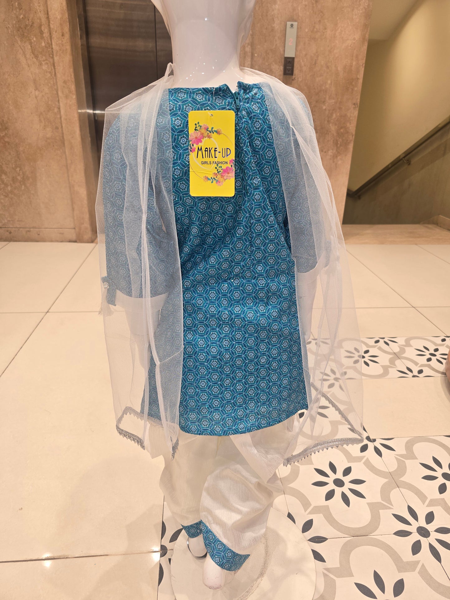 girls' ethnic salwar suit set, featuring a teal or sky-blue short printed kurti paired with white dhoti-style salwar pants