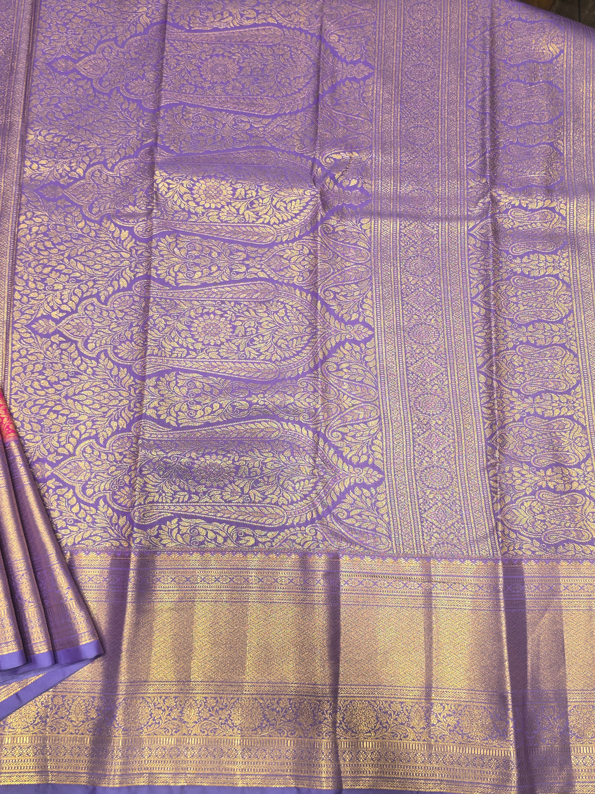 semi silk saree featuring a vibrant magenta body accented by a deep violet or purple contrast border.
