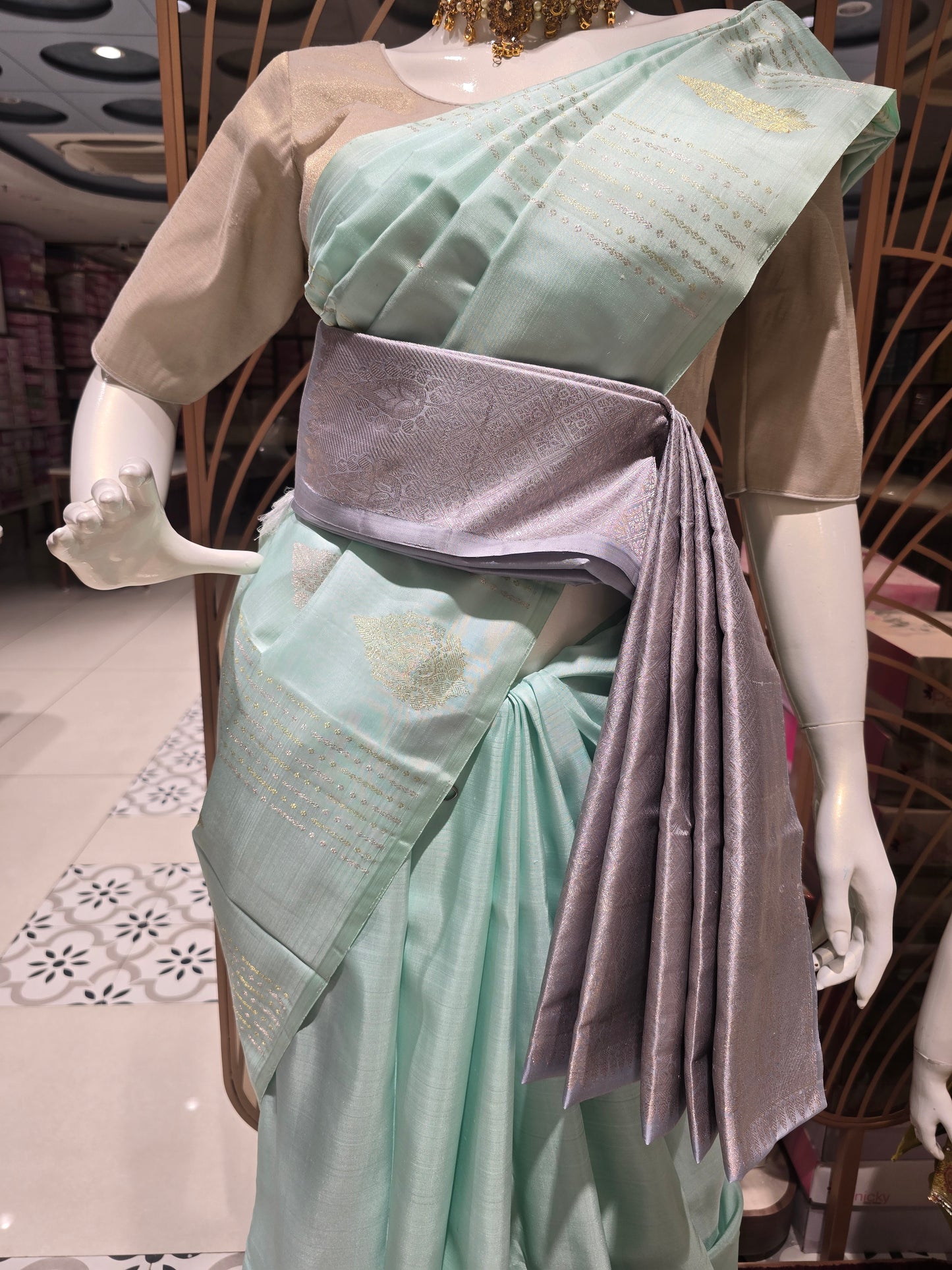 pastel mint green traditional silk saree styled with a contemporary contrasting lavender-grey fabric waist belt (kammarbandh) and an elegant,