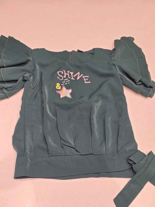dark green girl's party top featuring short, ruffled butterfly sleeves and an elasticated bottom hem with a matching side tie-up sash