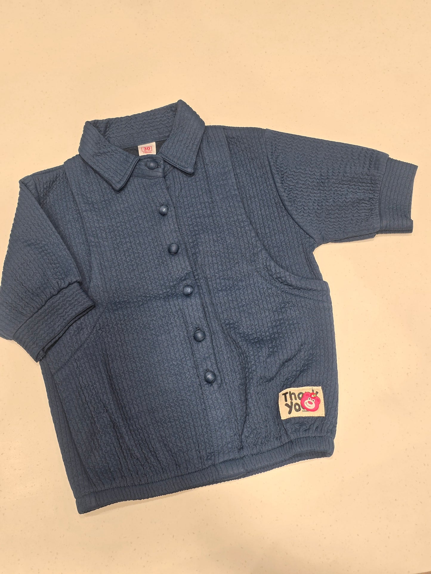 dark blue, smocked or waffle-textured kids' casual shirt