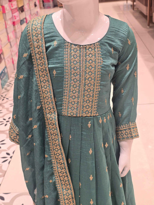 Rama green or teal-toned silk pleated Anarkali gown styled with an intricately embroidered bodice and a matching border dupatta.