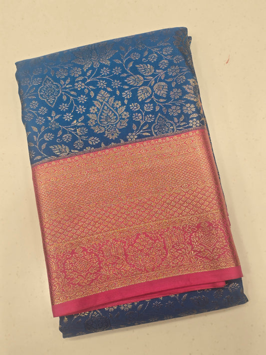 royal blue and rani pink semi-silk saree featuring rich gold zari brocade weaving.